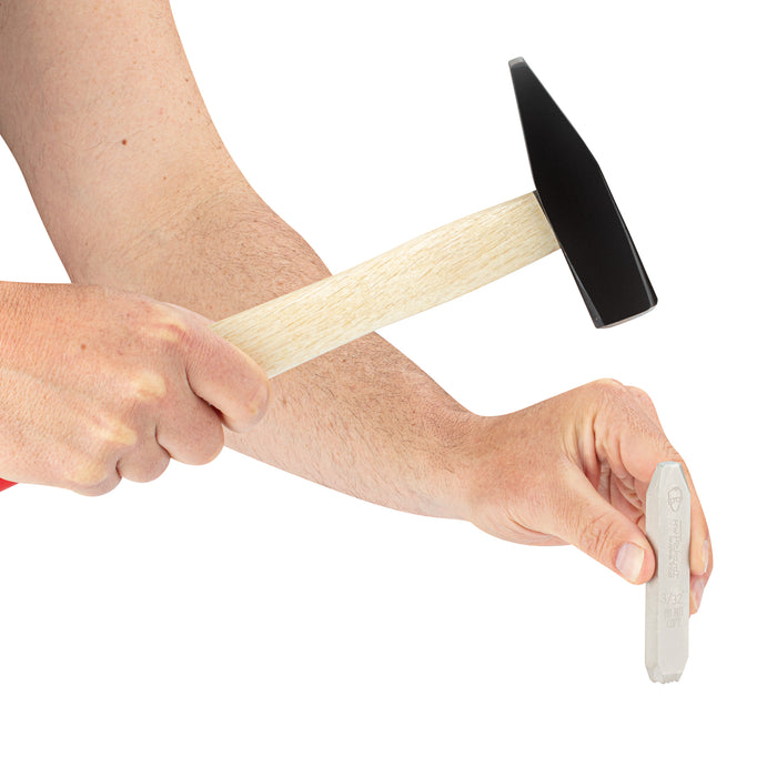 Pickardt Markint Tools HAnd Stamp "Do Not Copy" held in a hand, with a hammer being held in the other hand, ready to strike the hand stamps.