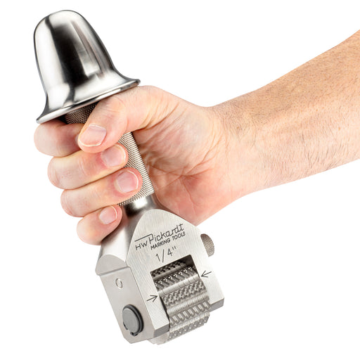 Pickardt Numbering head with striking cap being held in a hand Showing its size